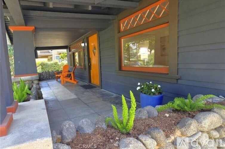 A house with a grey exterior and a blue planter box.