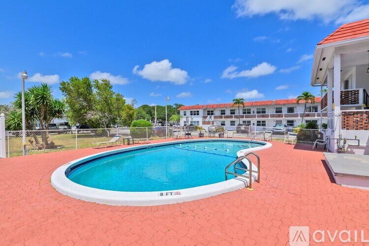 A pool with a red floor and a white pool edge with the word "BEYOND" written on it.