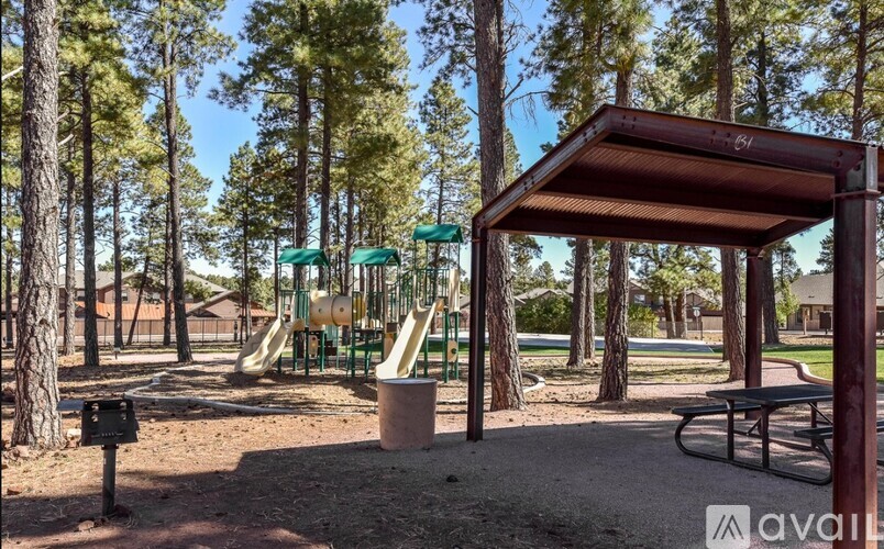 A playground with a slide and a canopy.
