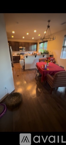 A kitchen with a dining table and chairs.