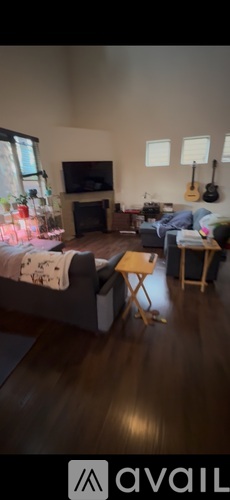 A living room with a grey couch and a wooden coffee table.