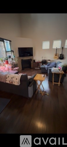 A living room with a grey couch and a wooden coffee table.