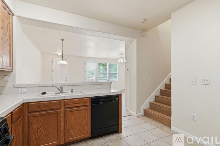 A kitchen with wooden cabinets and black appliances.