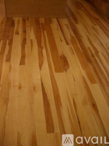 A wooden floor with a logo that says "avail".