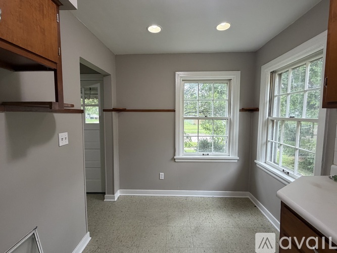 A room with a window and a sink.