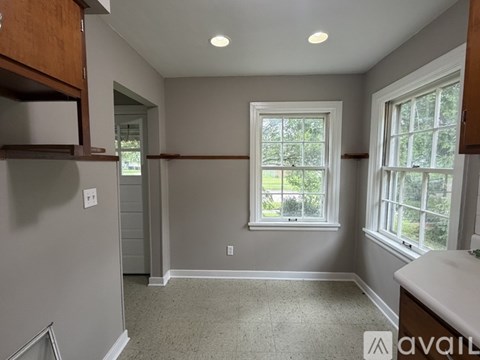 A room with a window and a sink.