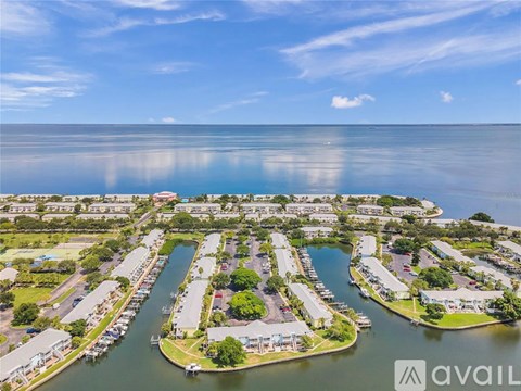 A bird's eye view of a marina with boats and houses.