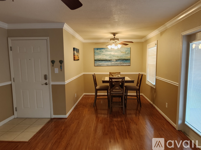 A dining room with a wooden table and chairs.