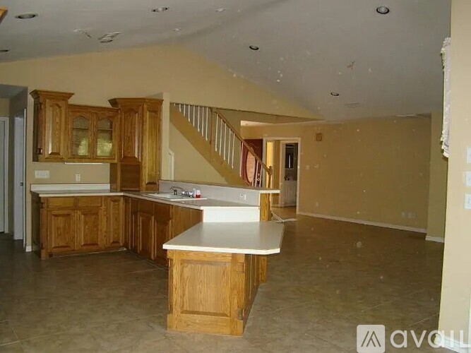A kitchen with wooden cabinets and a countertop is shown.