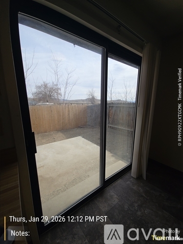 A view of a backyard through a sliding glass door.