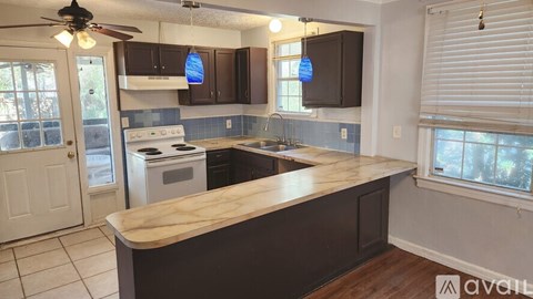 A kitchen with a wooden counter top and a white stove.
