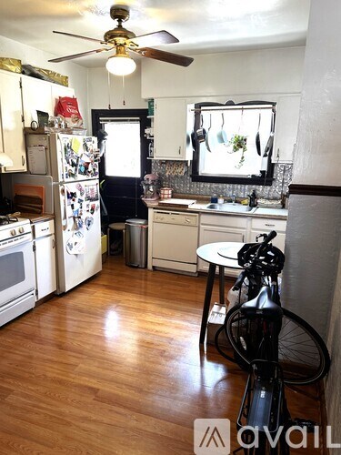A kitchen with a bicycle in the foreground.