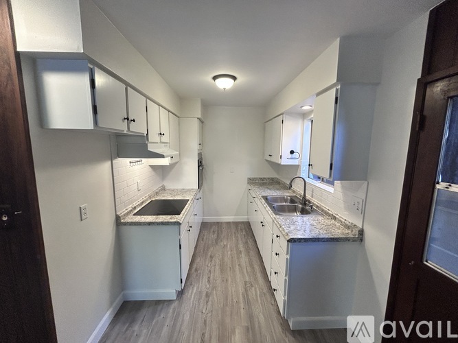 A kitchen with a sink and a counter top.