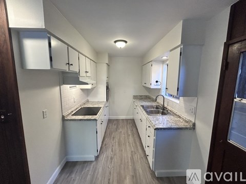 A kitchen with a sink and a counter top.