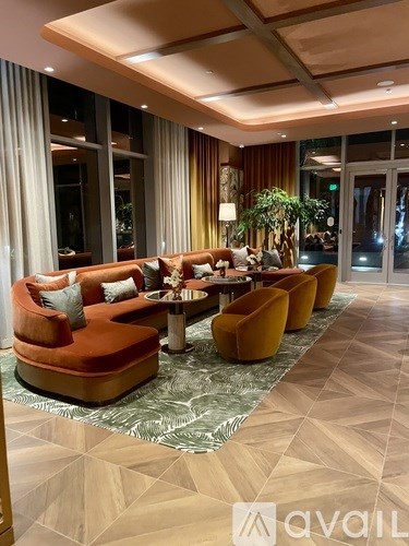 A living room with a long table and chairs.