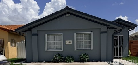 A grey house with the number 1413 on the front window.