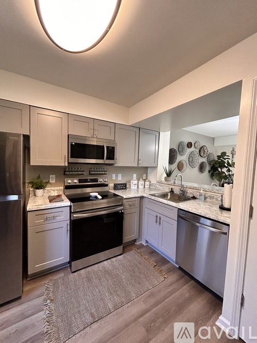 A modern kitchen with stainless steel appliances and a large island.