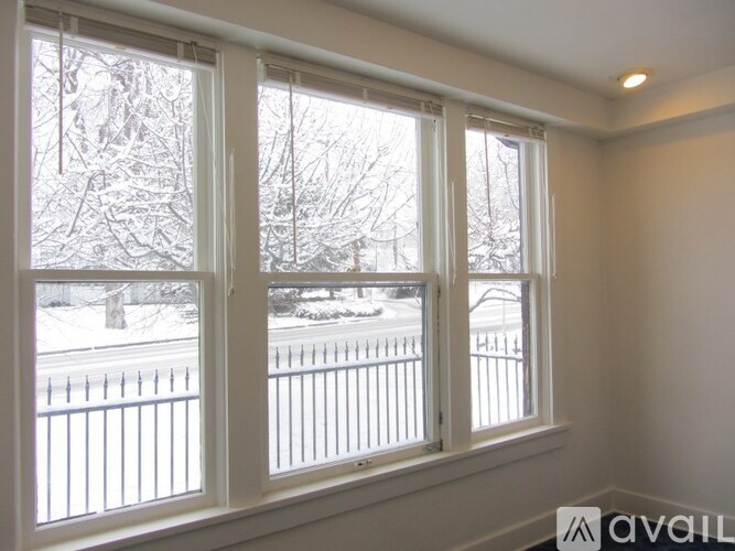 A room with a window showing a snowy landscape outside.