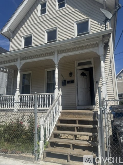 A house with a grey siding and a white door.