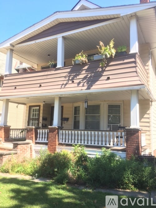 A house with a porch and a balcony.