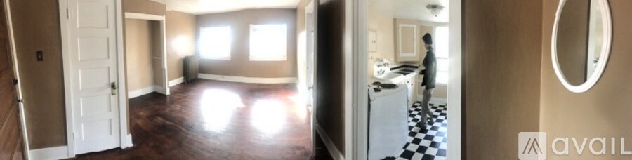 A hallway with a white door and a black and white checkered floor.