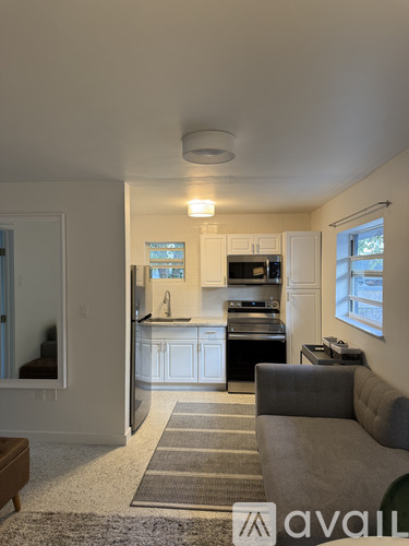 A kitchen with a dining table and a couch.
