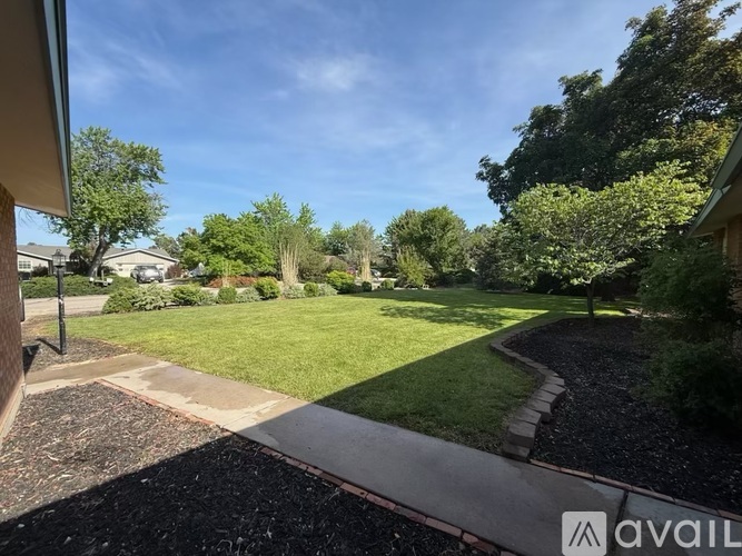 A backyard with a gravel path and a grassy area.