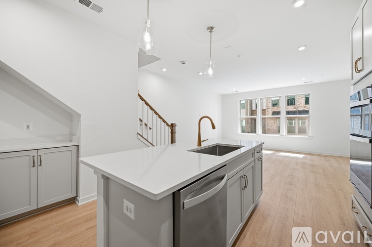 A modern kitchen with a large island and stainless steel appliances.