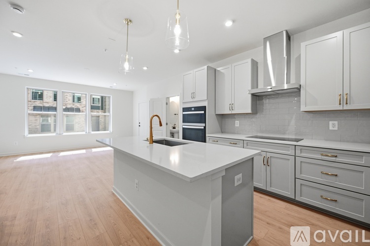 A modern kitchen with white cabinets and a central island.