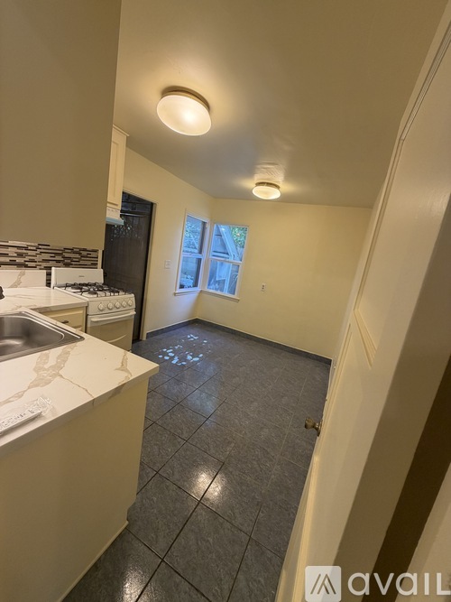 A kitchen with a white counter top and a window.