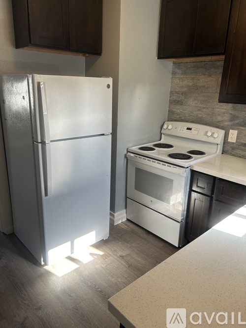 A kitchen with a white fridge and stove.