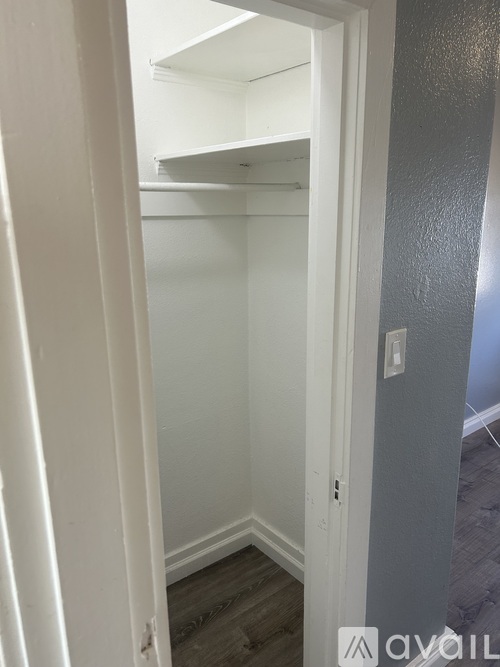 A white door with a small hole in the bottom left corner.