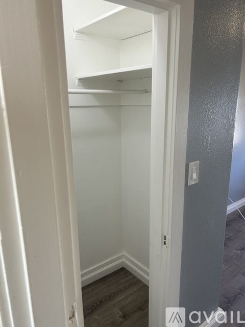 A white door with a small hole in the bottom left corner.