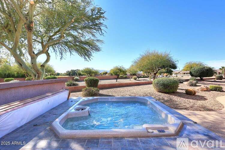 A pool surrounded by a desert landscape.