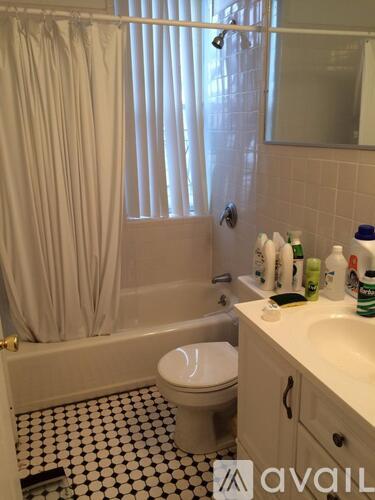 A bathroom with a toilet, sink, and shower.