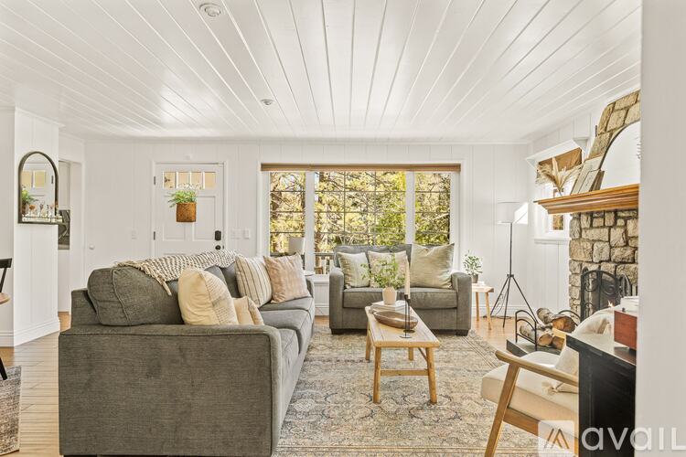 A living room with a grey couch and a wooden coffee table.