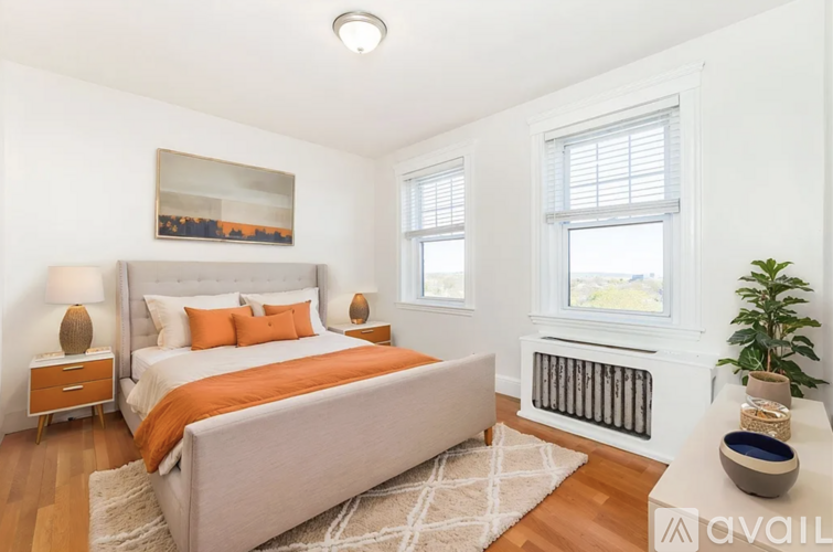 A bedroom with a large bed and a window.
