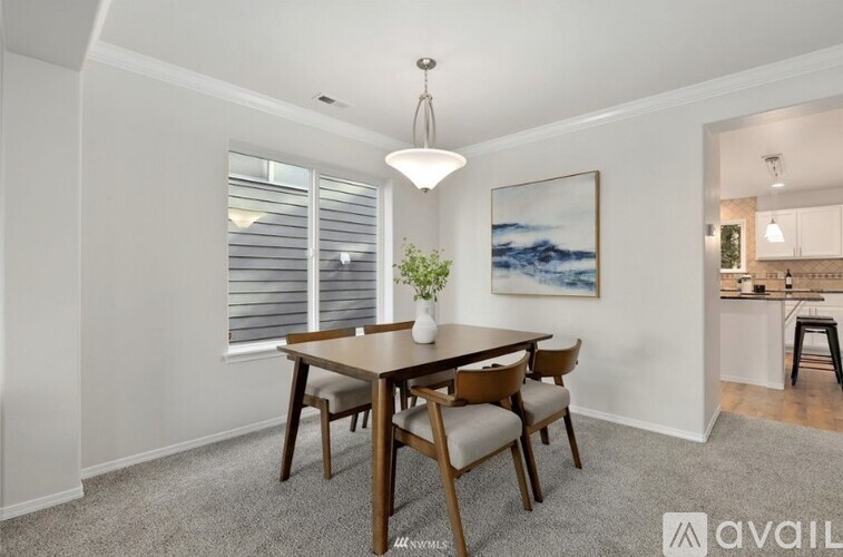 A dining room with a wooden table and chairs.
