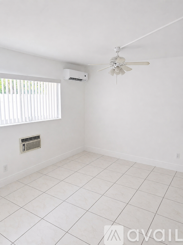 A room with a ceiling fan and air conditioner unit.