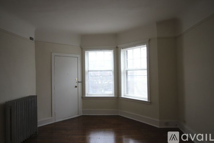 A room with a door, a window and a radiator.