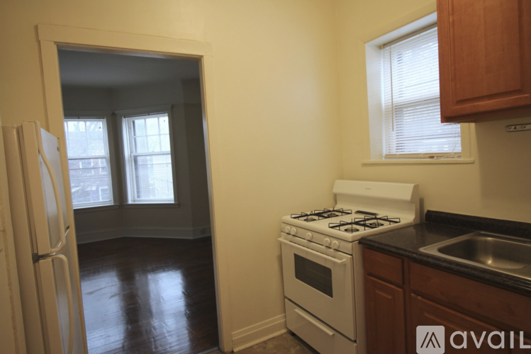 A kitchen with a white stove and a white refrigerator.