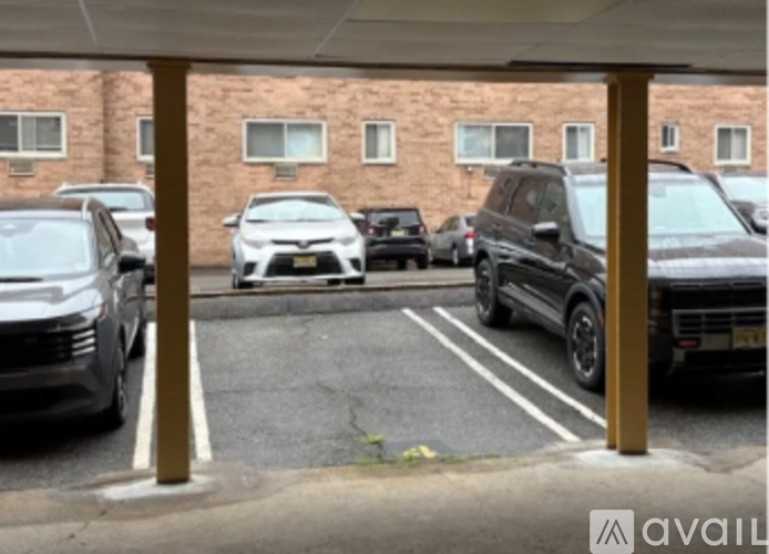 A parking lot with cars and a building in the background.