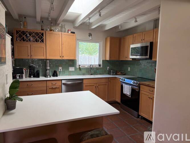 A kitchen with wooden cabinets and a white countertop.