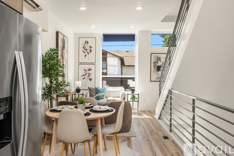 A modern kitchen with a dining table and chairs.