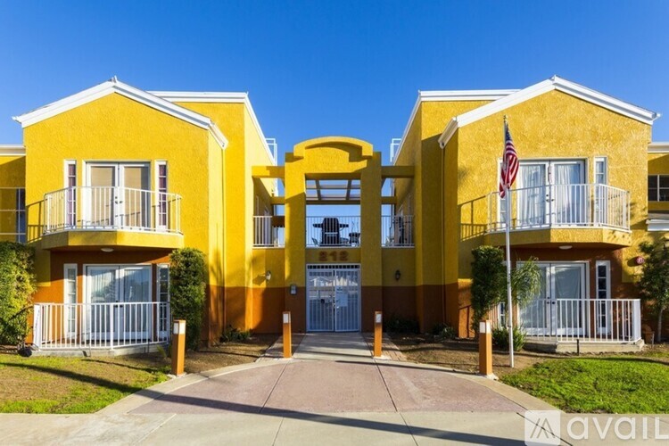A yellow building with a flag on top of it.
