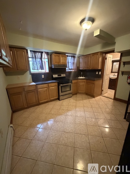 A kitchen with wooden cabinets and black appliances.
