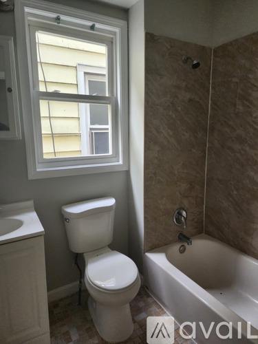 A bathroom with a toilet, sink, and bathtub.