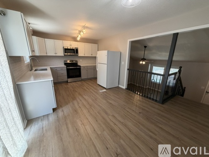 A kitchen with a refrigerator, stove, and oven.