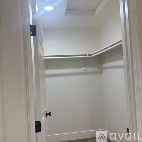 A white door with a black handle is open.