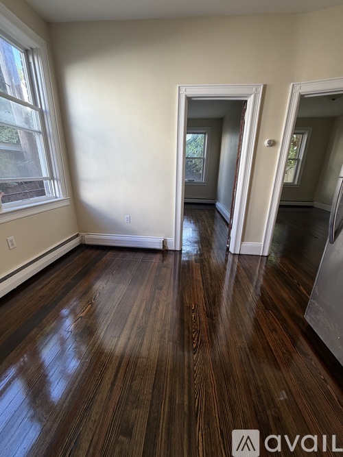 A room with wooden floors and a window.